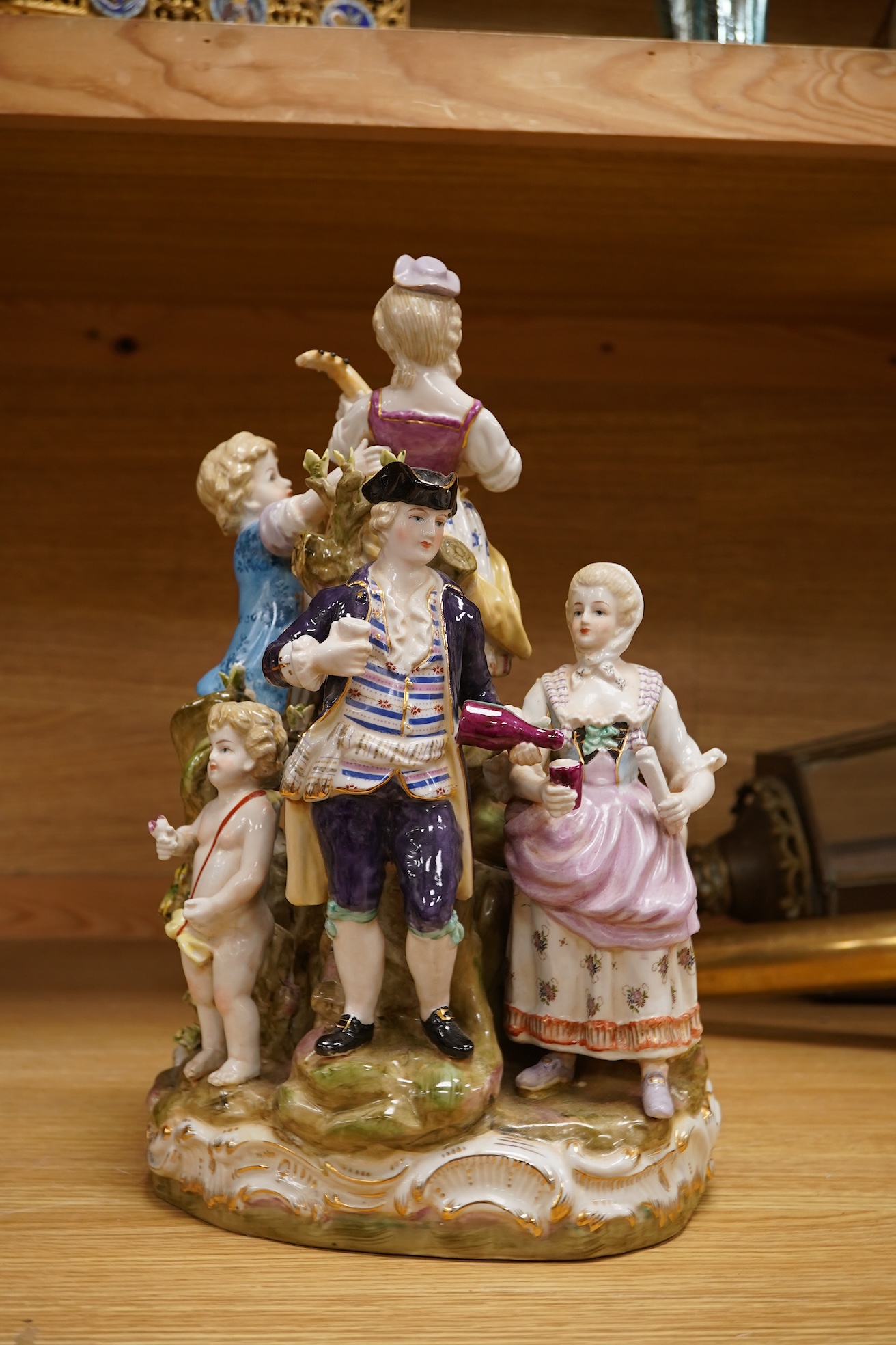 A large German porcelain group, figures playing instruments, 35cm high